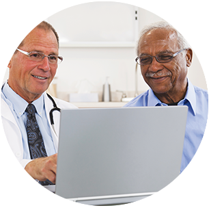 Doctor and patient sitting together with laptop
